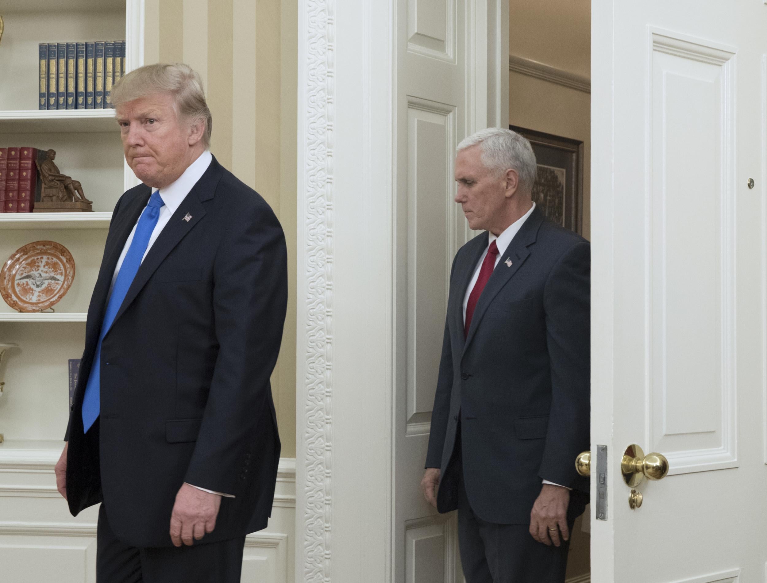 US President Donald J. Trump (L) and US Vice President Mike Pence (R) enter the Oval Office