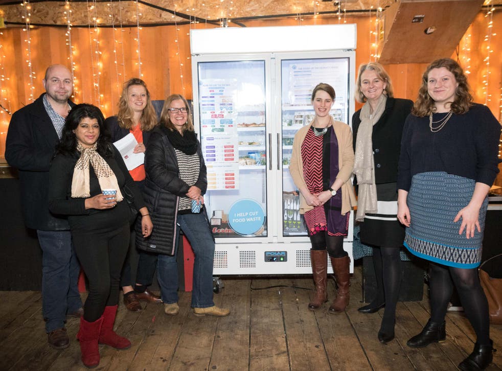 Campaigners behind The People's Fridge, including Olivia Haughton right of centre, unveil the giant cooler on the launch night