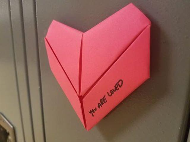 A student made 1,300 origami hearts with the message "you are loved" for all the students and staff in her school for Valentine's Day