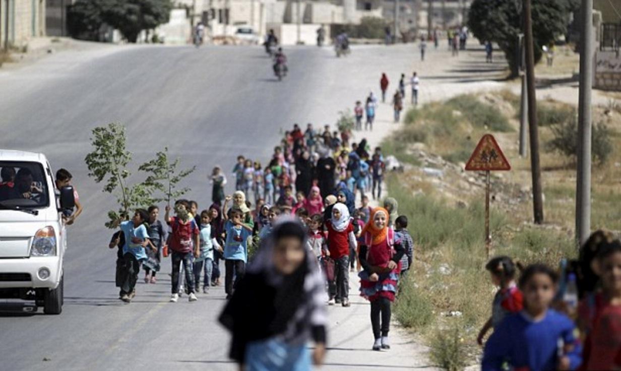 Children walk to school in Idlib province, where religious police have been rigorously enforcing their interpretation of sharia-compliant dress codes for women and girls