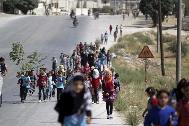 Children walk to school in Idlib province, where religious police have been rigorously enforcing their interpretation of sharia-compliant dress codes for women and girls