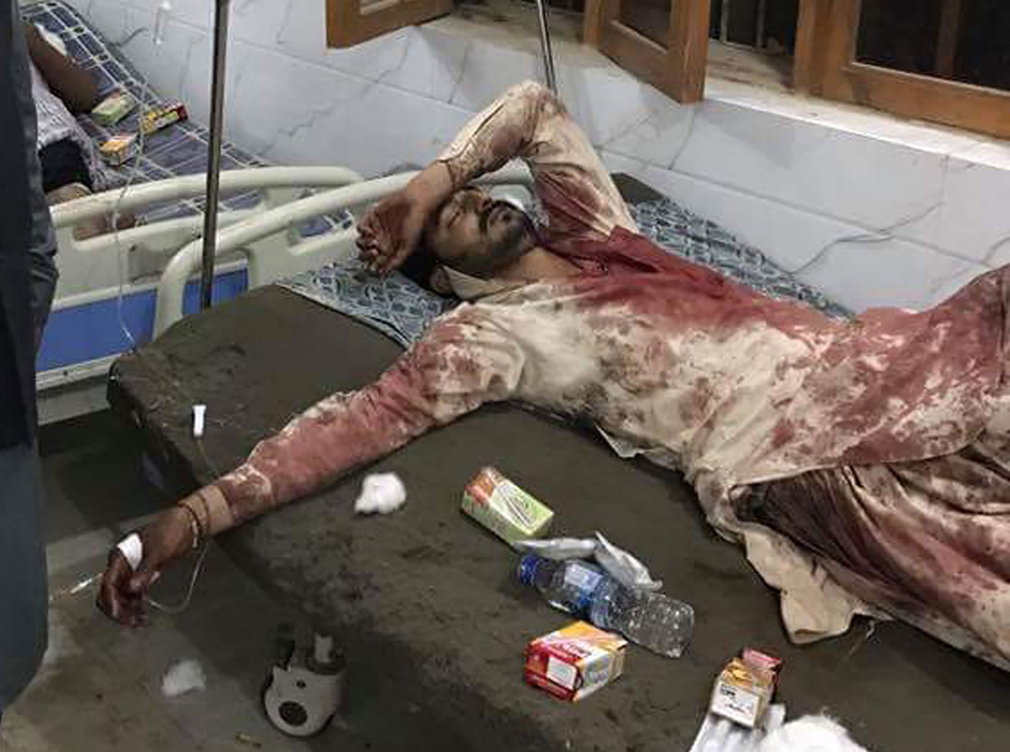 An injured man is treated at a local hospital after an explosion Lal Shahbaz Qalandar in Sehwan on 16 February