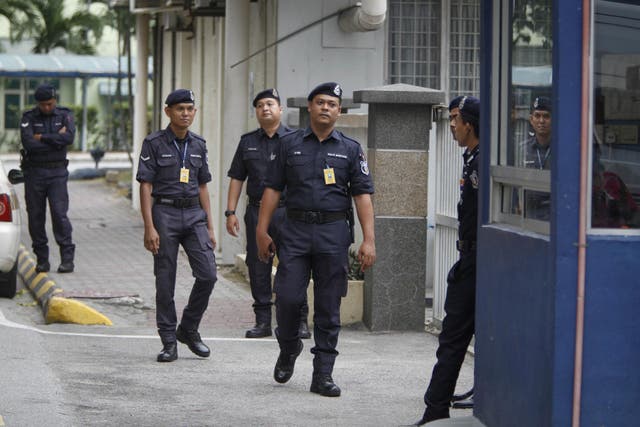 Police officers patrol outside the forensic department at Kuala Lumpur Hospital in Kuala Lumpur, Malaysia