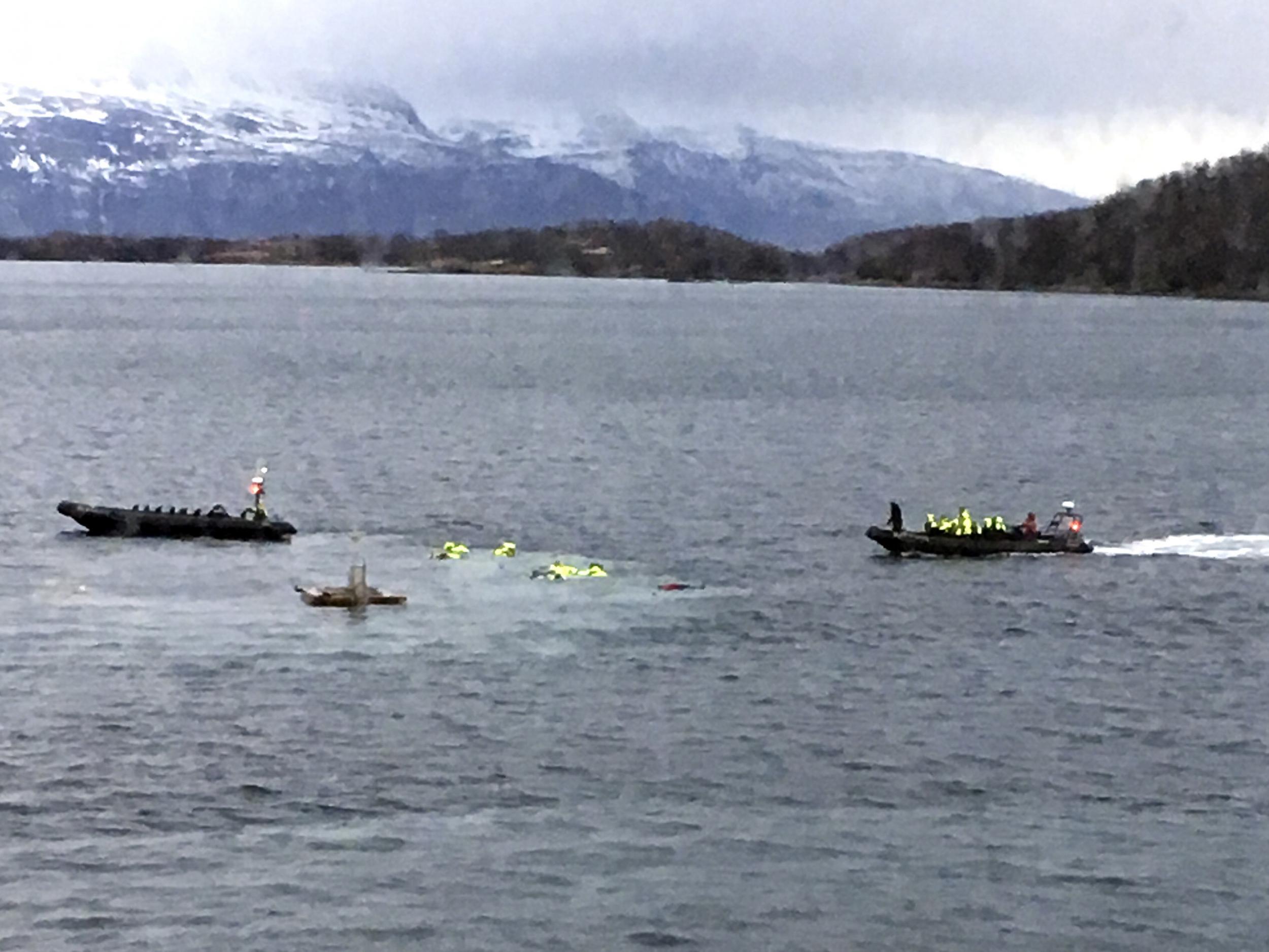 A boat picks up tourists from the water after an accident in Harstad harbour in Northern Norway