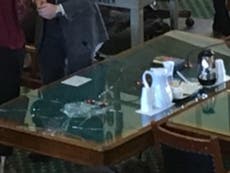 Anti-abortion lawmaker shatters glass table to silence woman