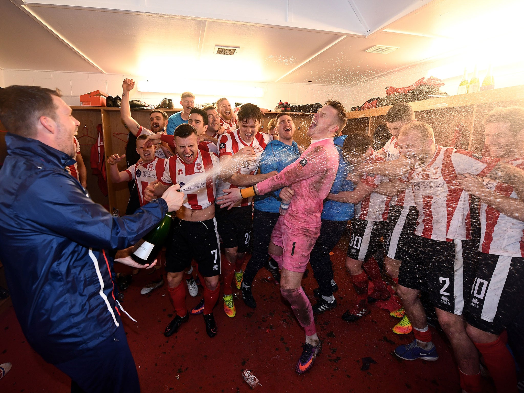 Lincoln's players celebrate after their historic FA Cup fourth-round victory over Brighton