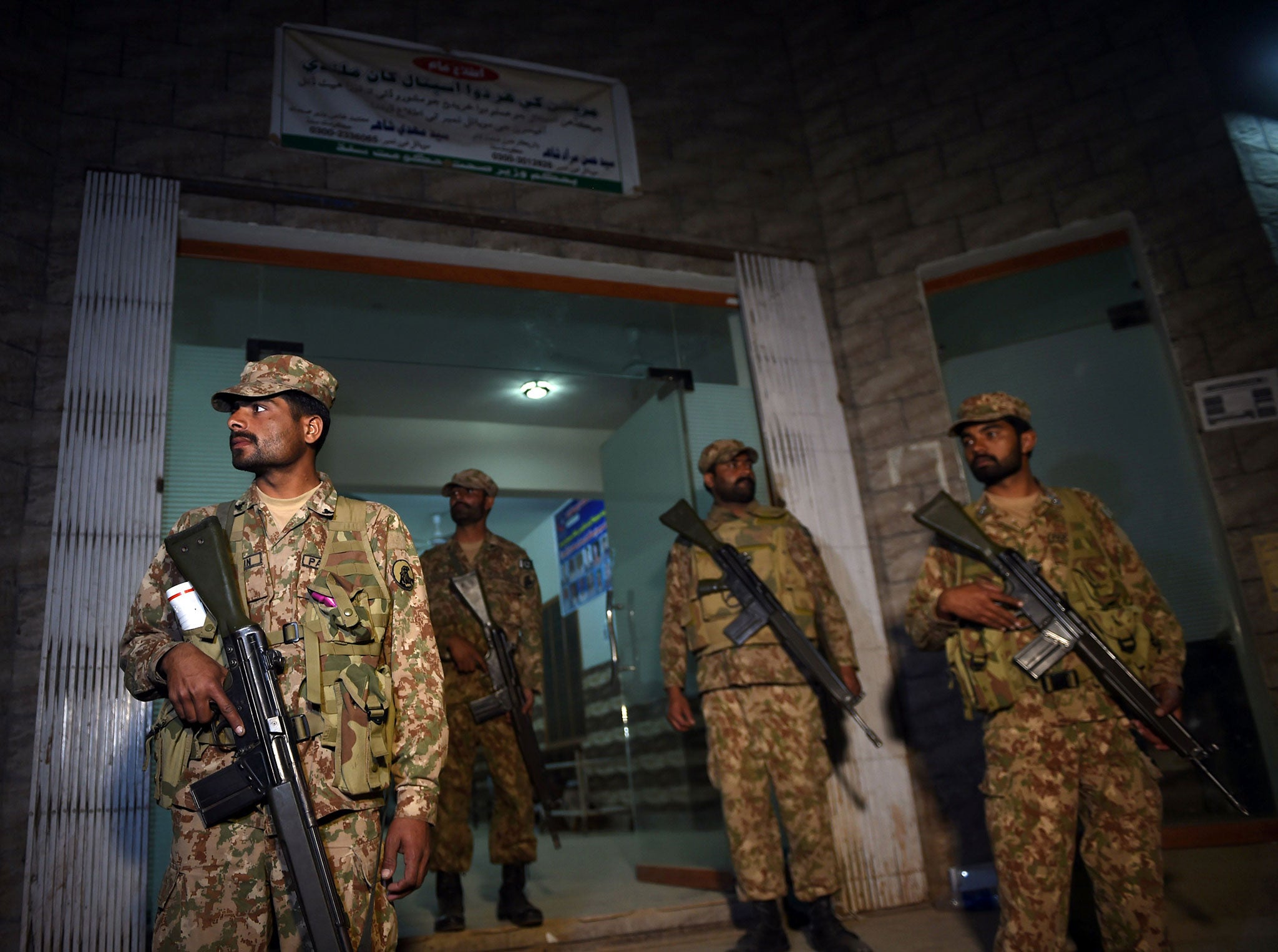 Pakistani soldiers stand guard at the entrance of a local hospital in the town of Sehwan on 17 February 2017,