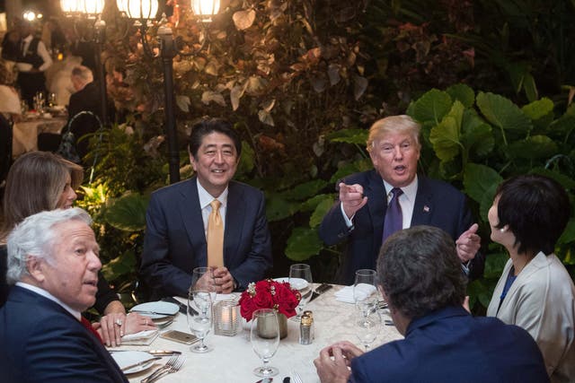 Donald Trump, with Japan Prime Minister Shinzo Abe, his wife, Melania Trump, and New England Patriots owner Robert Kraft, in Mar-a-Lago