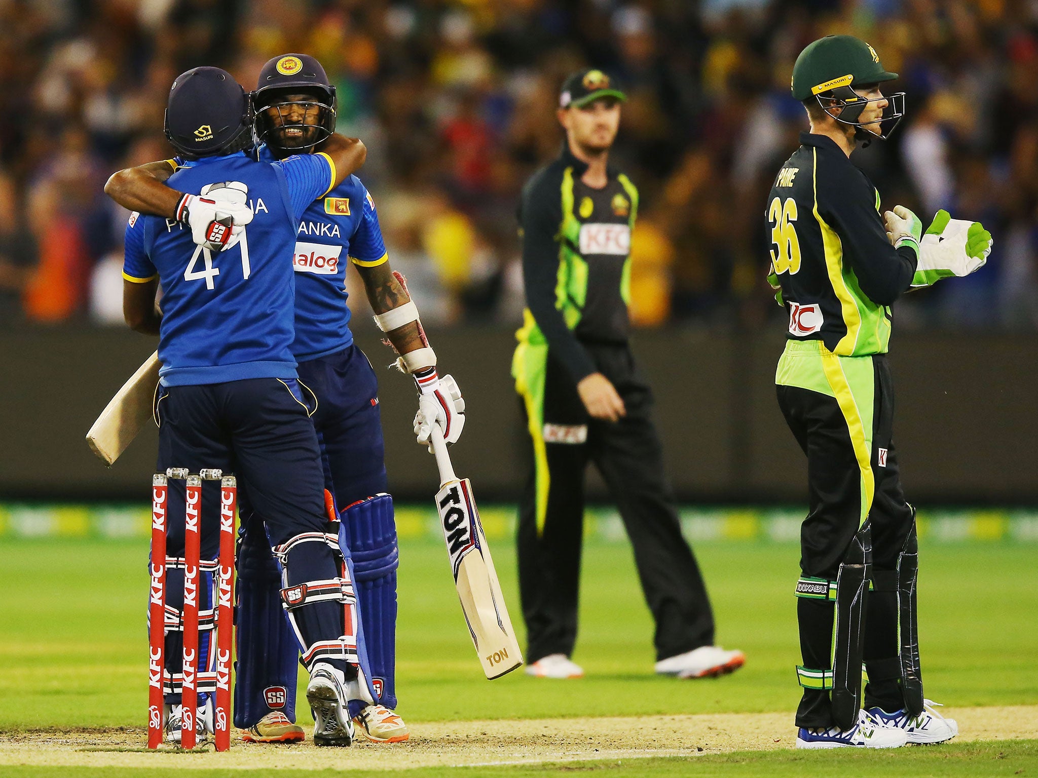 Chamara Kapugedera celebrates with Seekkuge Prasanna after hitting the winning runs