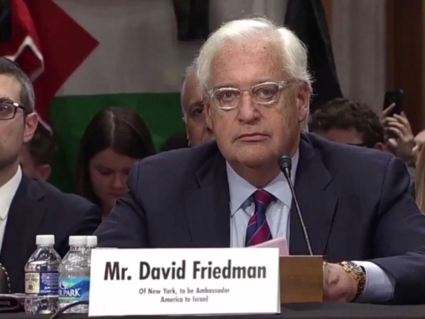 David Friedman paused during his statement as a protester heckled