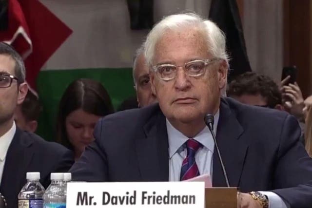 David Friedman paused during his statement as a protester heckled