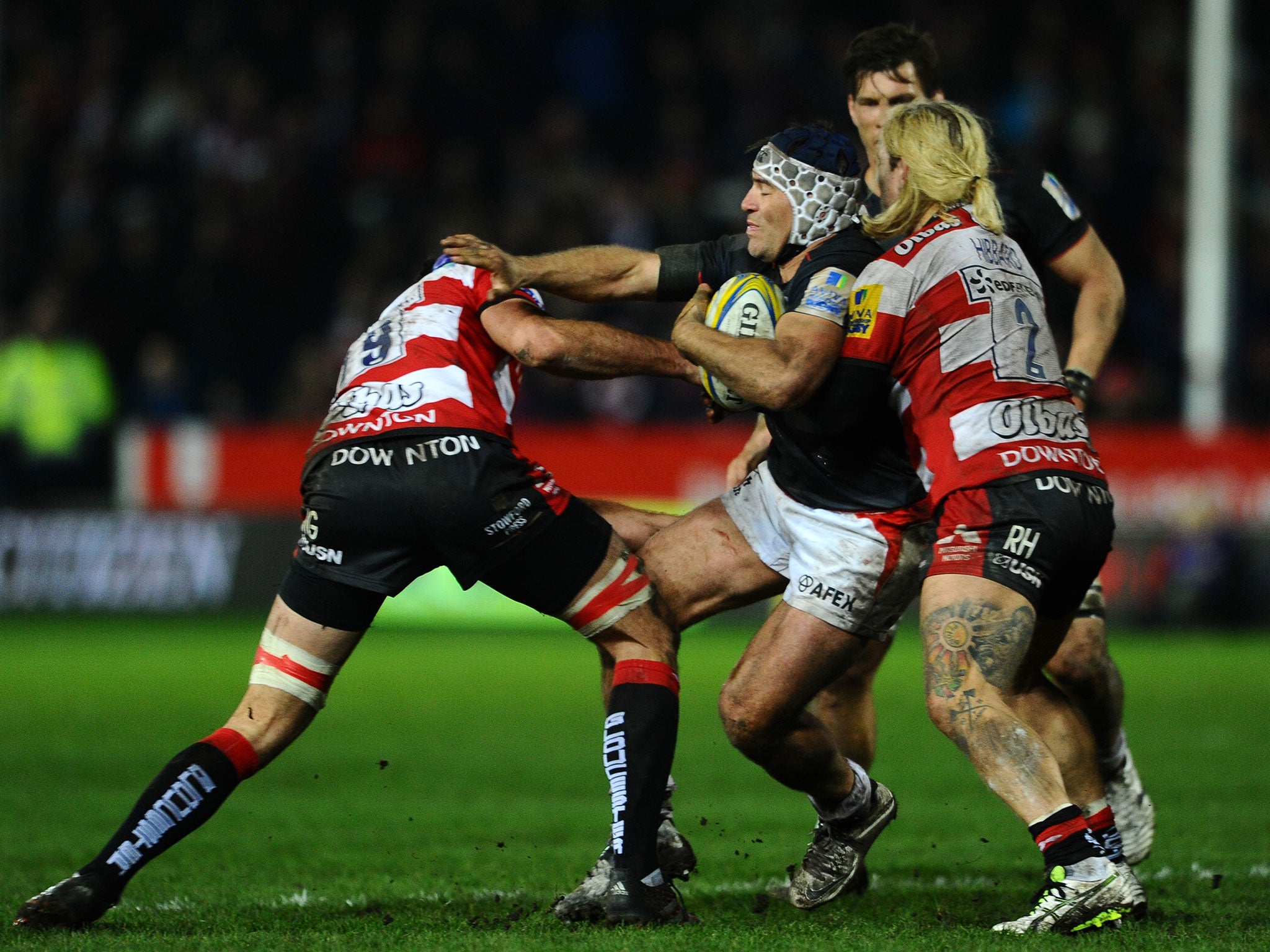 Schalk Brits of Saracens is tackled by Mariano Galarza of Gloucester