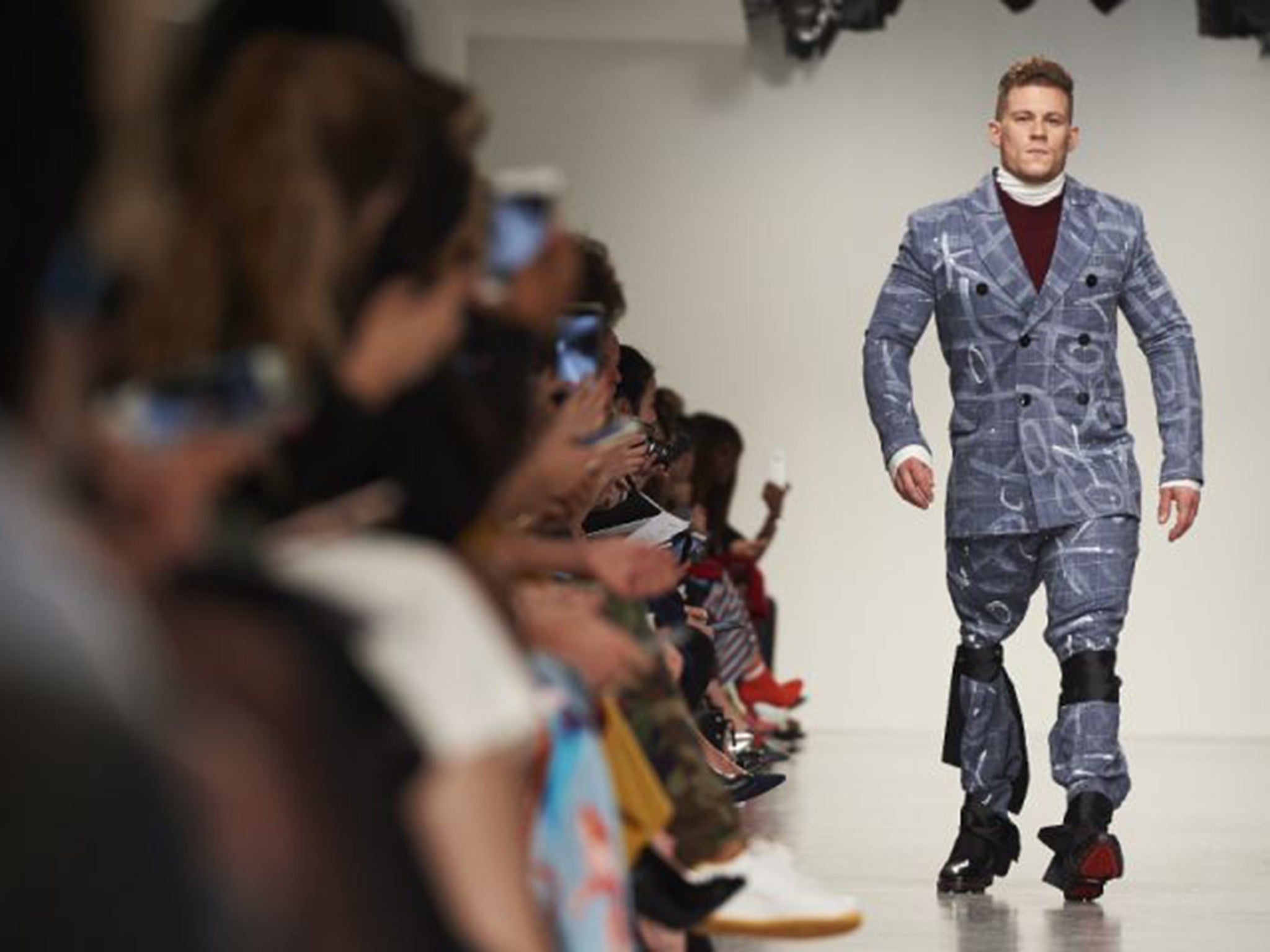 Model Jack Ayers, who uses a prosthetic limb, on the catwalk for Teatum Jones in London