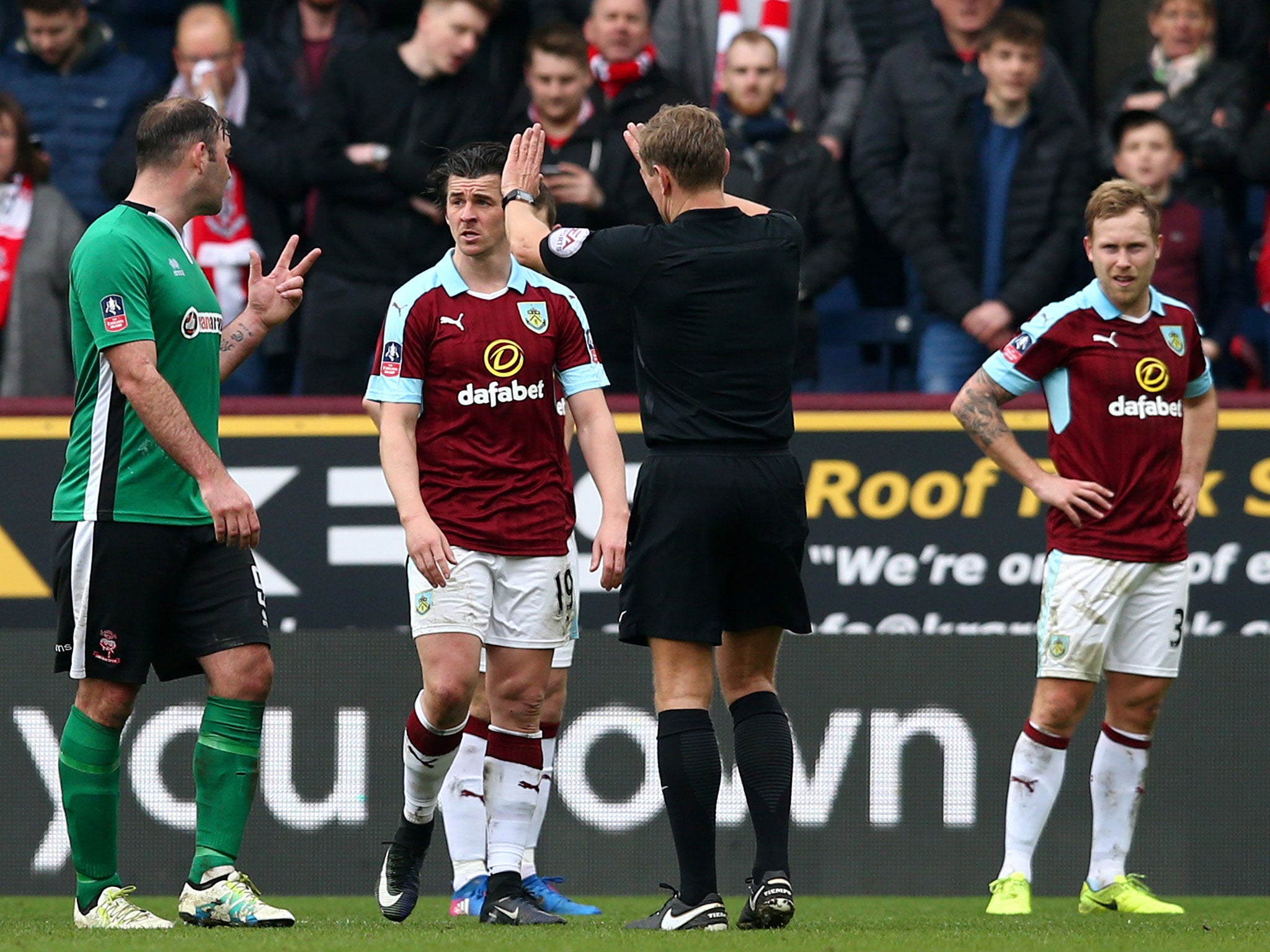 Joey Barton is shown a yellow card during Burnley's FA Cup clash with Lincoln