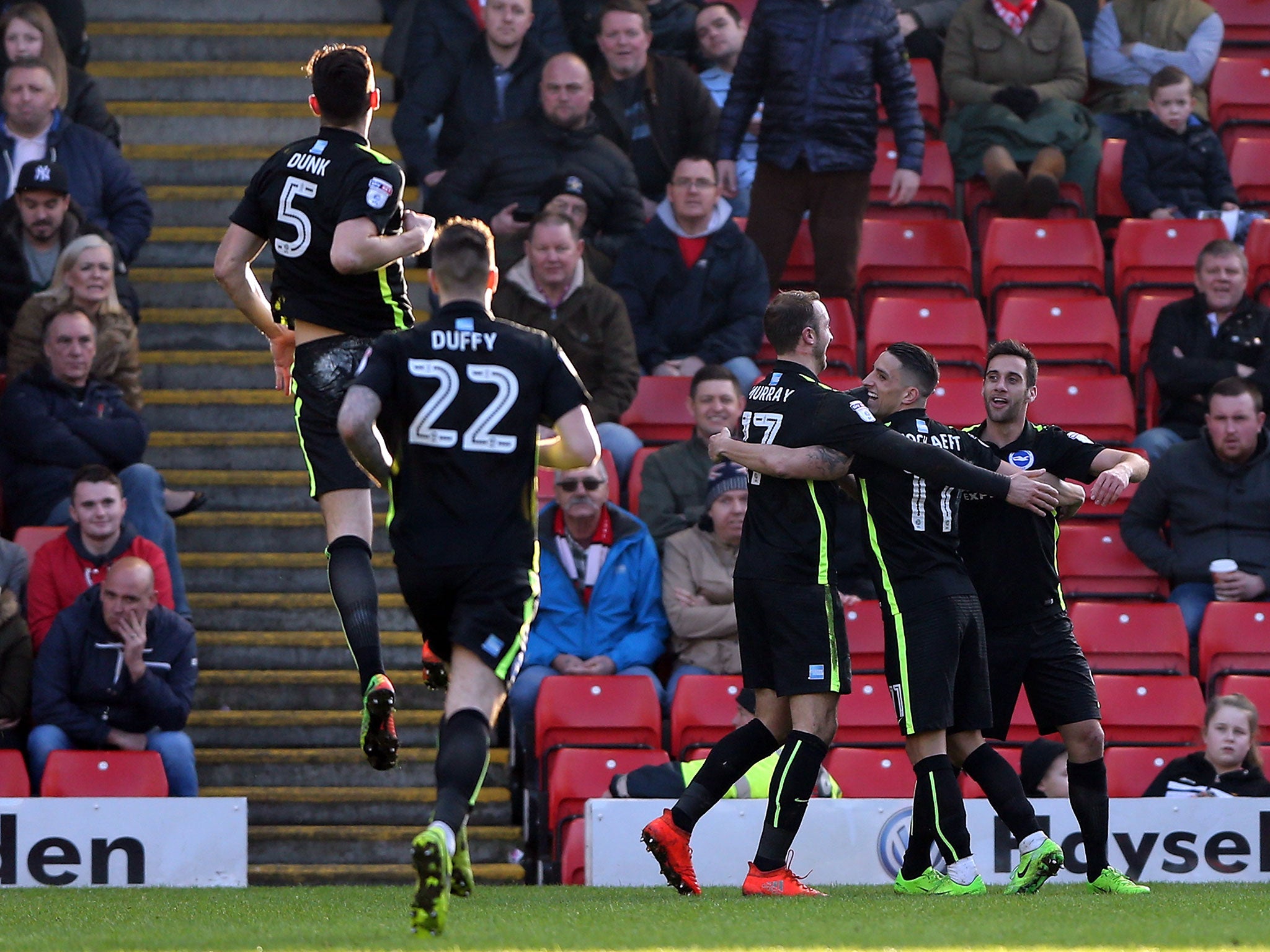 Sam Baldock celebrates with his team-mates after scoring his second for Brighton