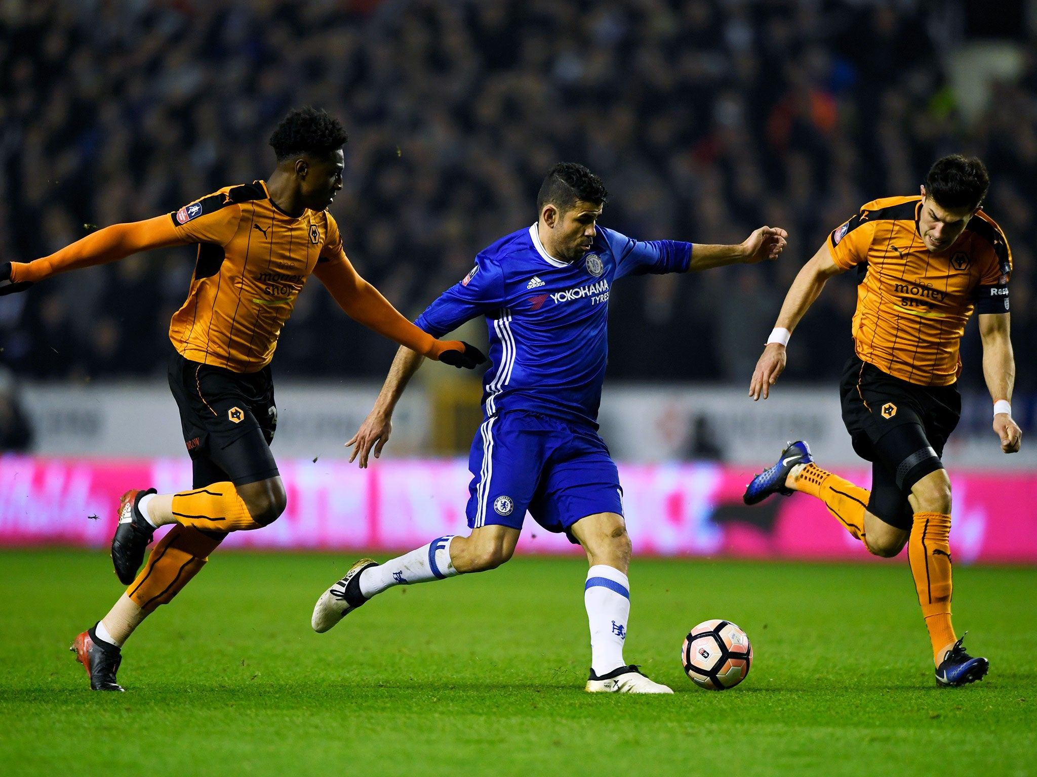 Costa is closed down by two Wolves players