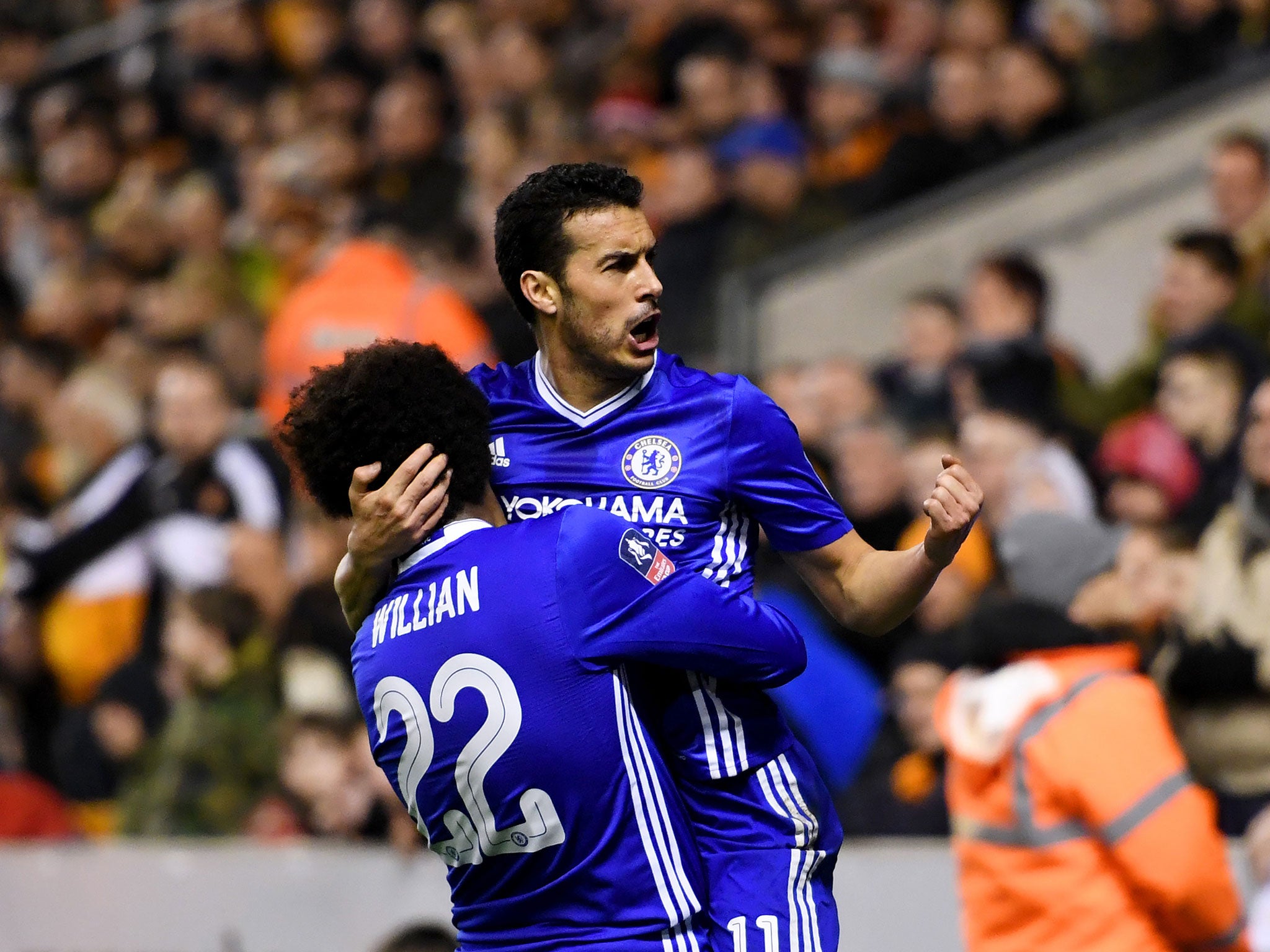 Pedro celebrates with Willian after scoring for the visitors