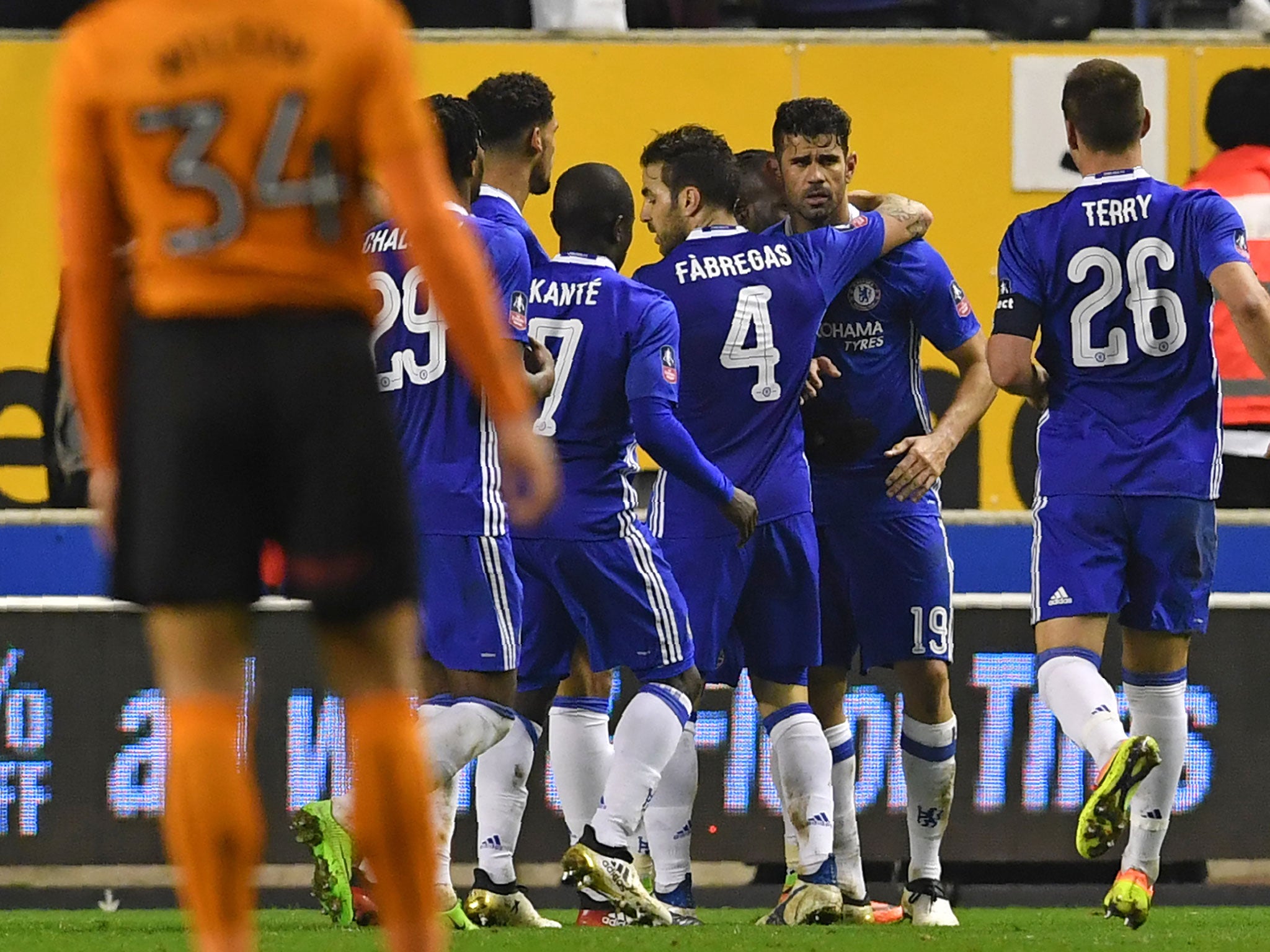 Costa is congratulated by his team-mates after scoring Chelsea's second
