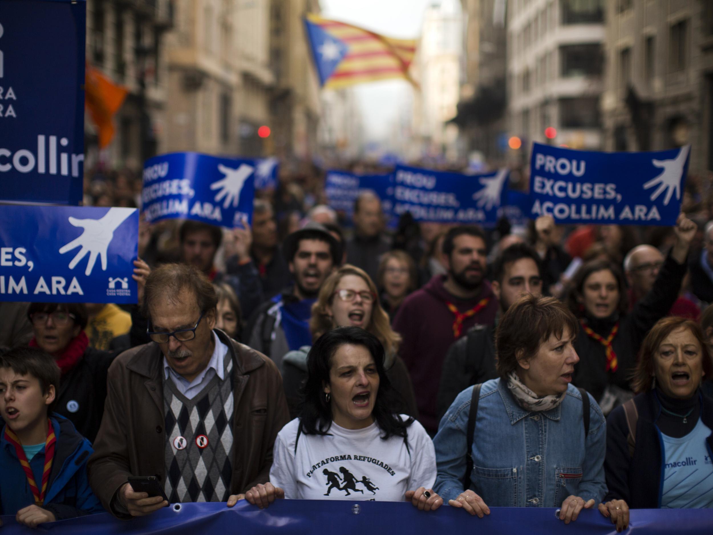 Demonstrators march as they take part in a protest along the street in downtown Barcelona, Spain