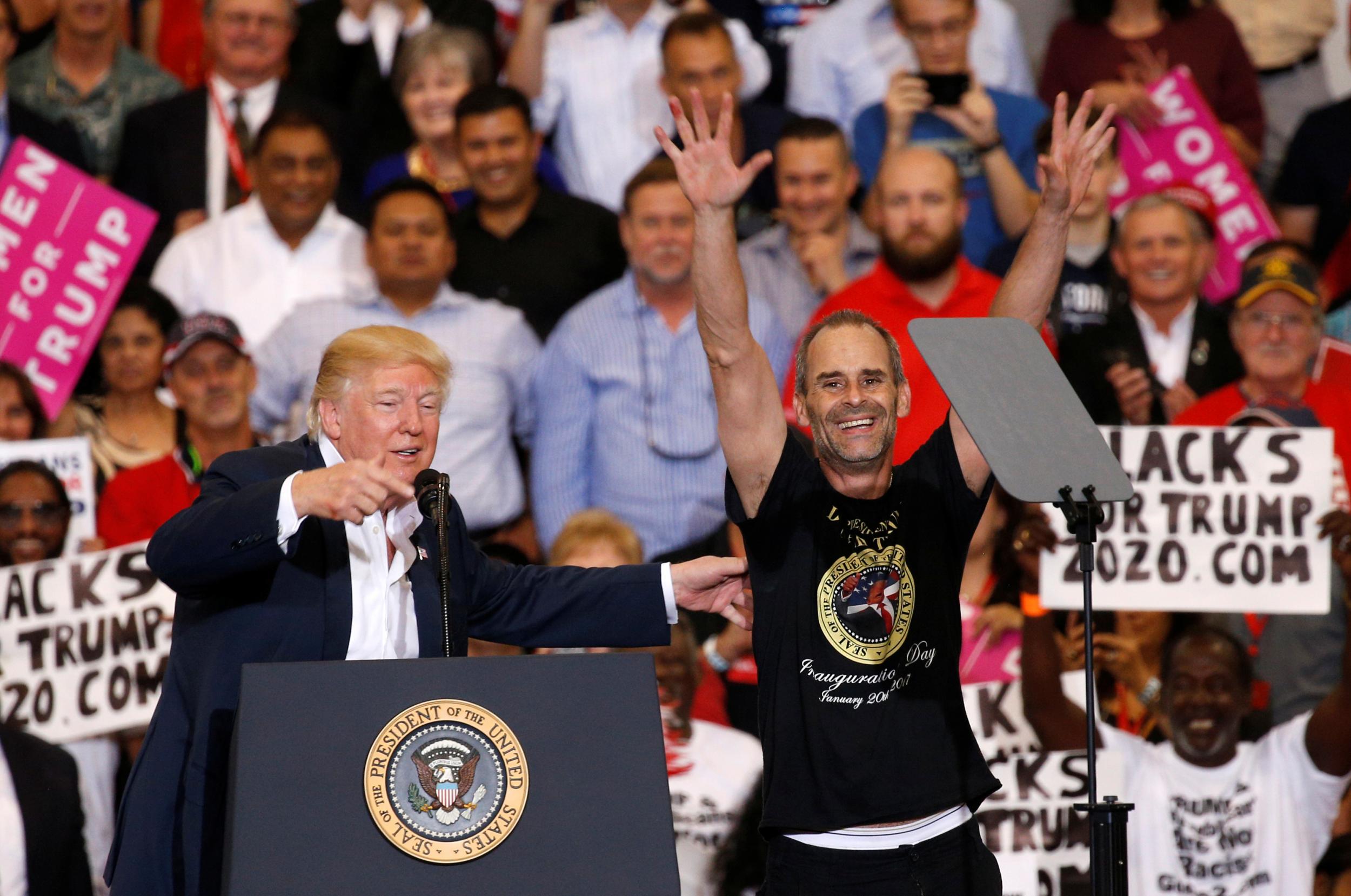 U.S. President Donald Trump invites a supporter onstage with him during a "Make America Great Again" rally at Orlando Melbourne International Airport in Melbourne, Florida, U.S. February 18, 2017