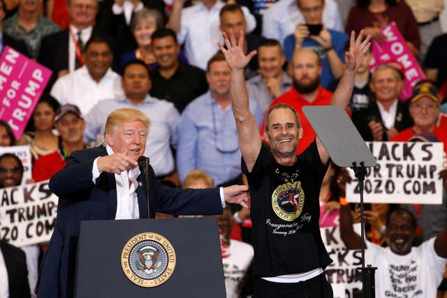 U.S. President Donald Trump invites a supporter onstage with him during a "Make America Great Again" rally at Orlando Melbourne International Airport in Melbourne, Florida, U.S. February 18, 2017