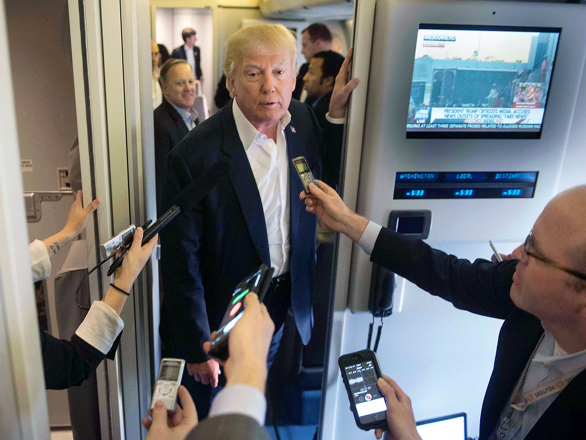 President Donald Trump speaks to the press aboard Air Force One