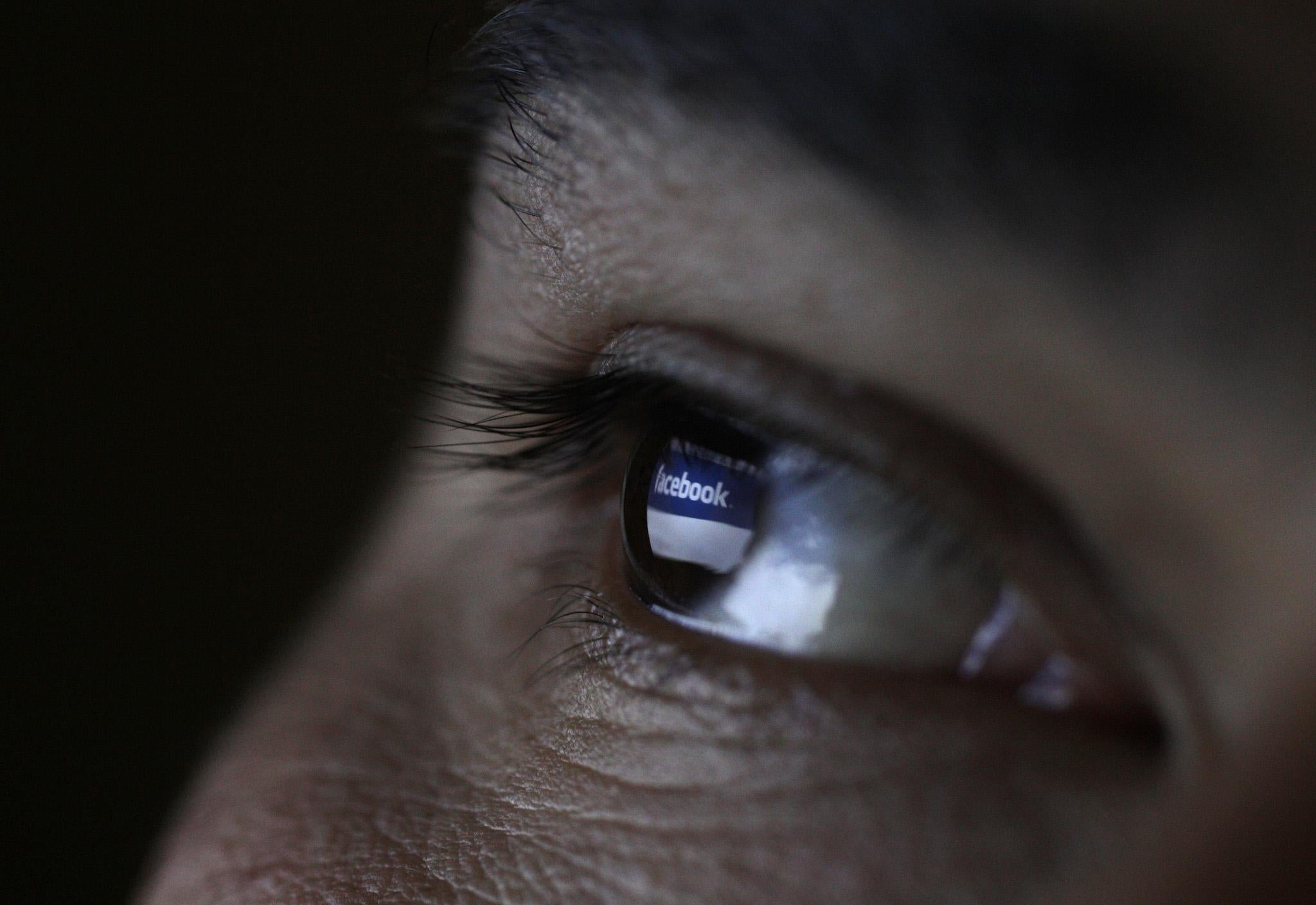 A picture illustration shows a man looking at the Facebook website on a tablet in Sofia June 27, 2012