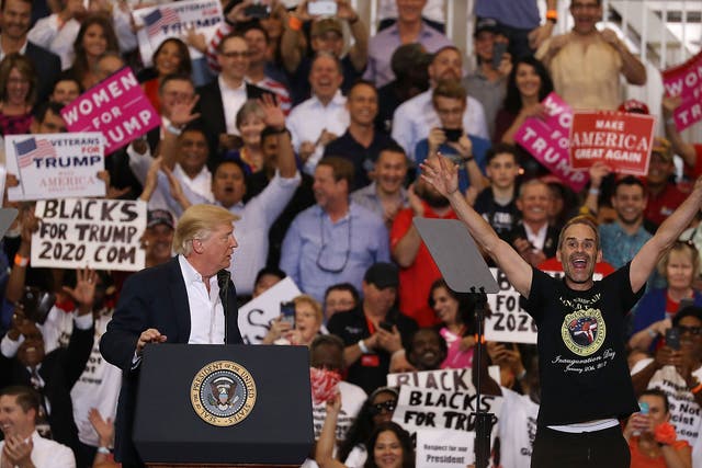 Blacks for Trump supporters waving placards behind Donald Trump during a rally in Florida last weekend