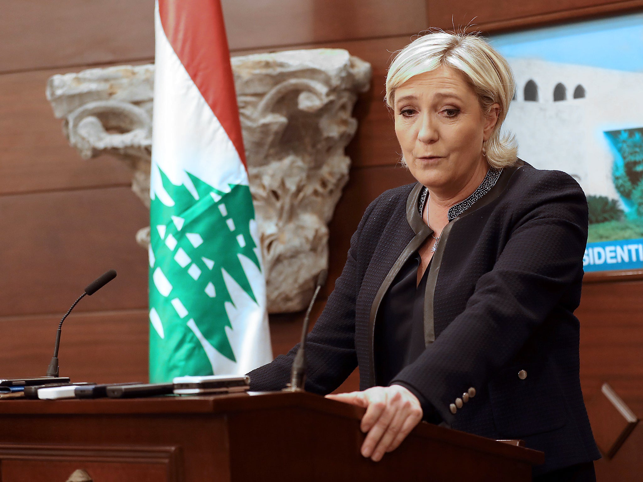 The French far-right leader speaks during a press conference at the presidential palace in Lebanon