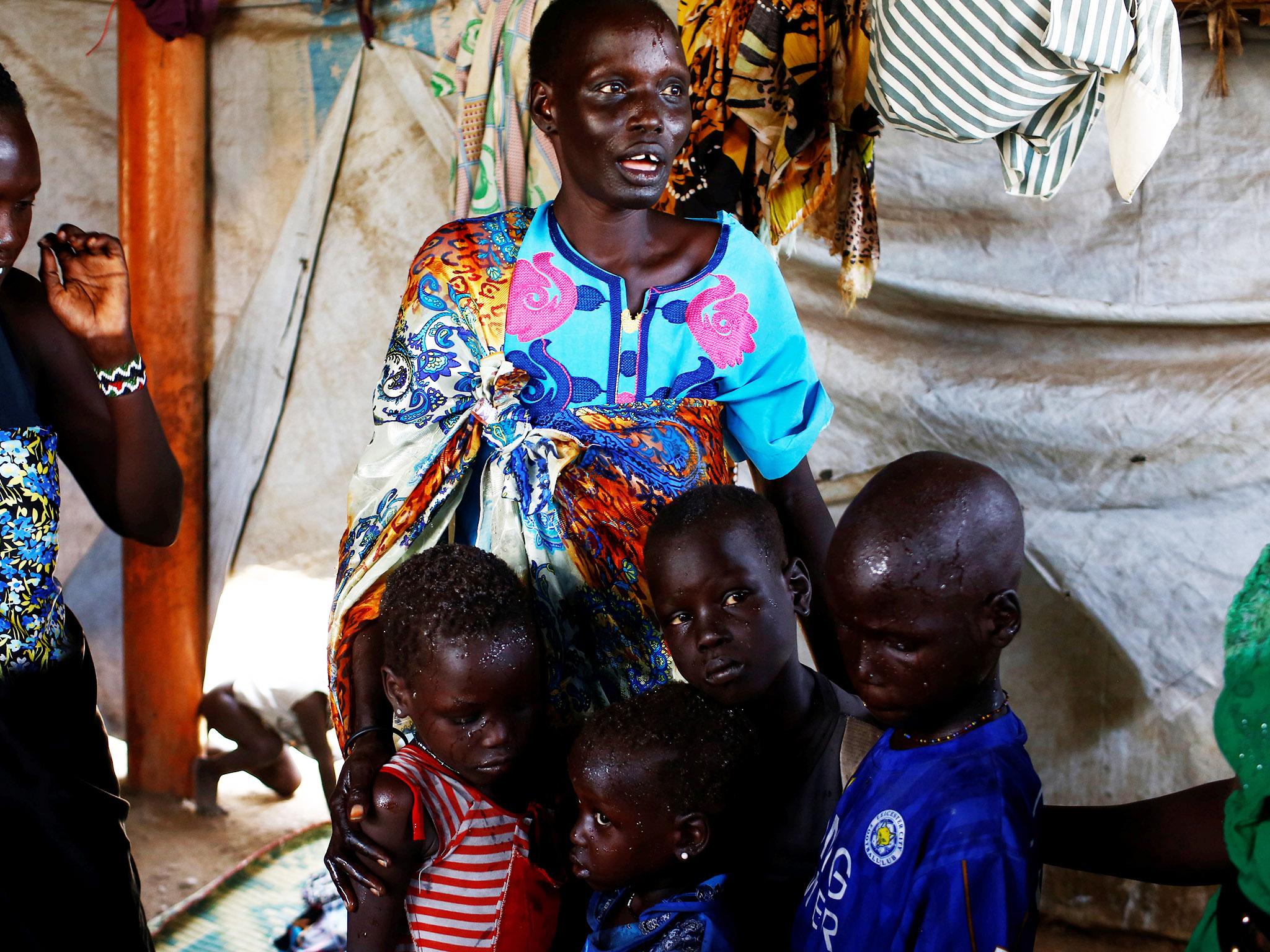 Nyagonga Machul, 38, embraces her children after being reunited at the United Nations mission in South Sudan