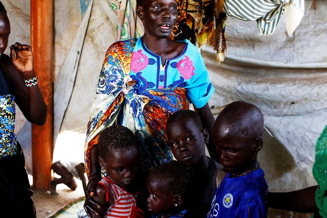 Nyagonga Machul, 38, embraces her children after being reunited at the United Nations mission in South Sudan