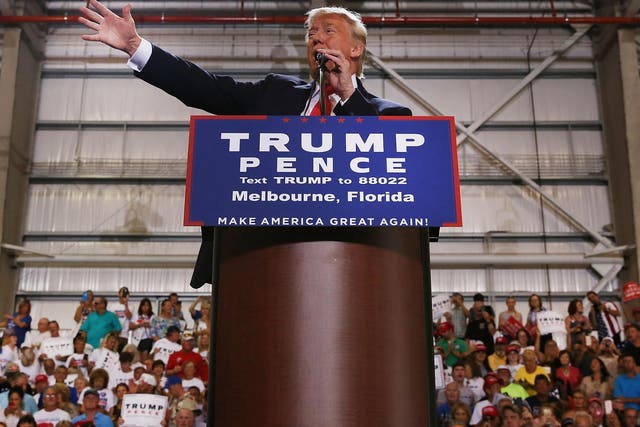 Donald Trump speaks to a large group of supporters at a Florida airport hanger