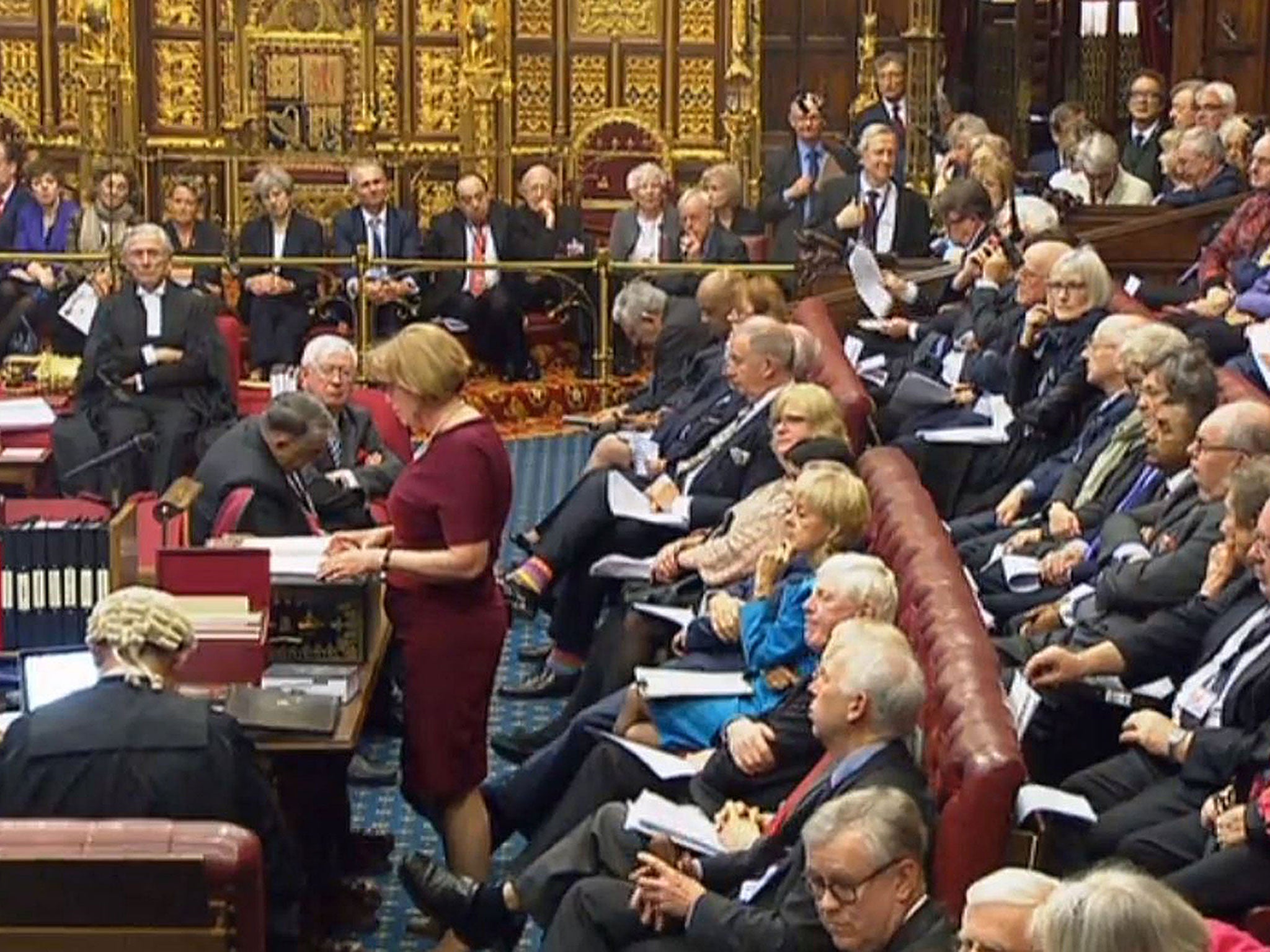 Theresa May watches from the steps of the Queen’s golden throne, as the House of Lords debates the Brexit bill
