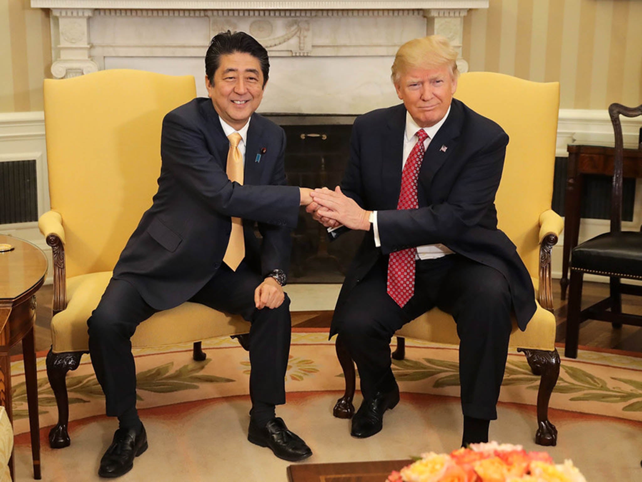 Patting down: the Donald held Japanese PM Shinzo Abe’s hand for a gruelling 19 seconds