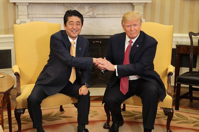Patting down: the Donald held Japanese PM Shinzo Abe’s hand for a gruelling 19 seconds