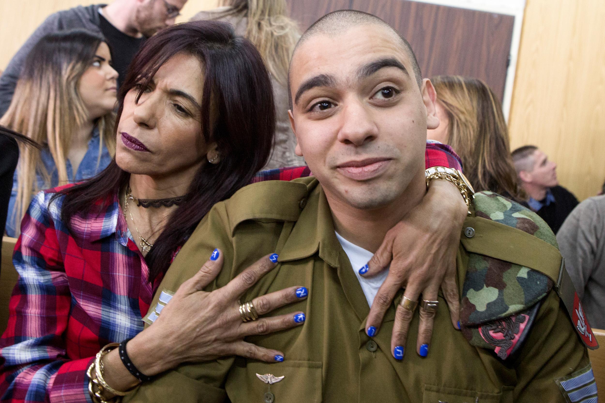Israeli soldier Elor Azaria is embraced by his mother at the start of his sentencing hearing in Tel Aviv (Reuters)