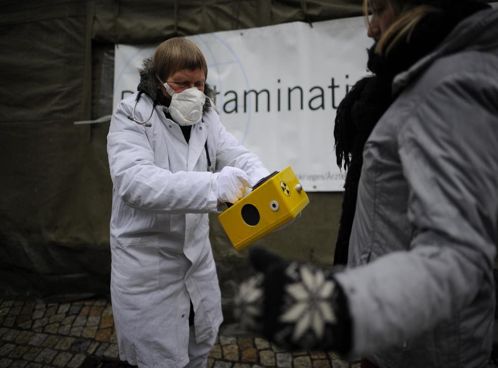 Anti-Nuclear protesters use a Geiger counter to measure the radioactive contamination of a citizen on March 9, 2013 in Hildesheim, Germany