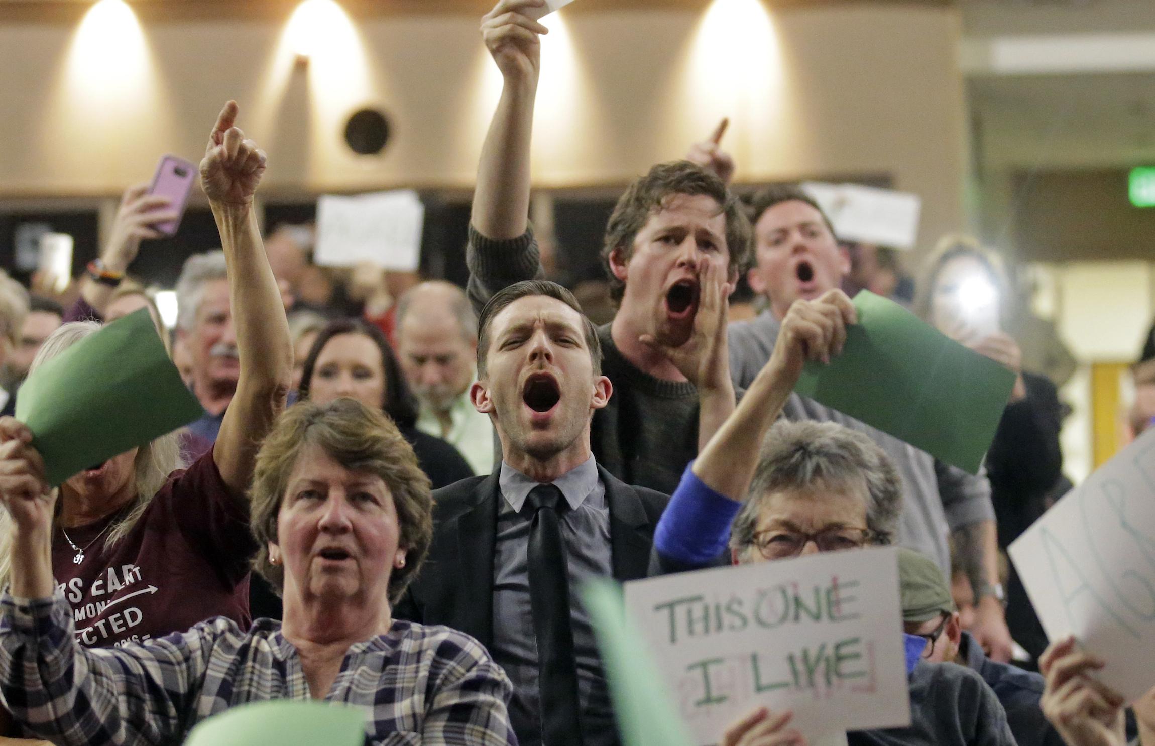 People shout at Representative Jason Chaffetz during his town hall meeting at Brighton High School on February 9, 2017 in Cottonwood Heights, Utah.