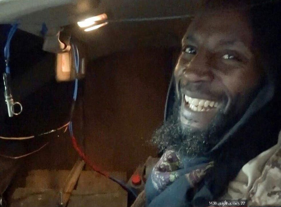 The terror group's Amaq news agency released a picture of a grinning al-Britani sat in his explosives-laden vehicle