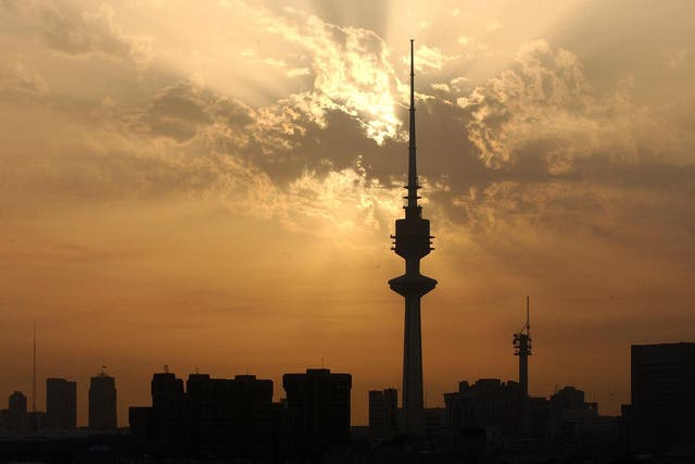 In this file picture, the sun sets on March 7, 2003 over the Kuwait City skyline. Most of the capital's rapid expansion has only been possible thanks to the labour of the Gulf State's estimated 2.9 million expatriate workers, who comprise roughly 70 per c