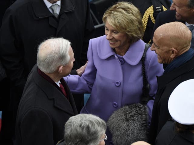 Betsy DeVos greets Jeff Sessions at the Inauguration