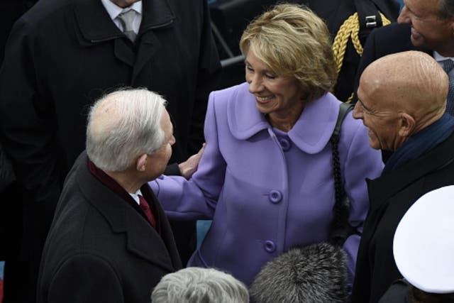 Betsy DeVos greets Jeff Sessions at the Inauguration