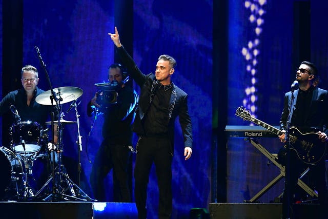 Robbie Williams performs on stage at the Brit Awards