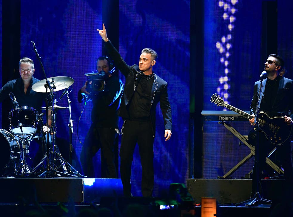 Robbie Williams performs on stage at the Brit Awards