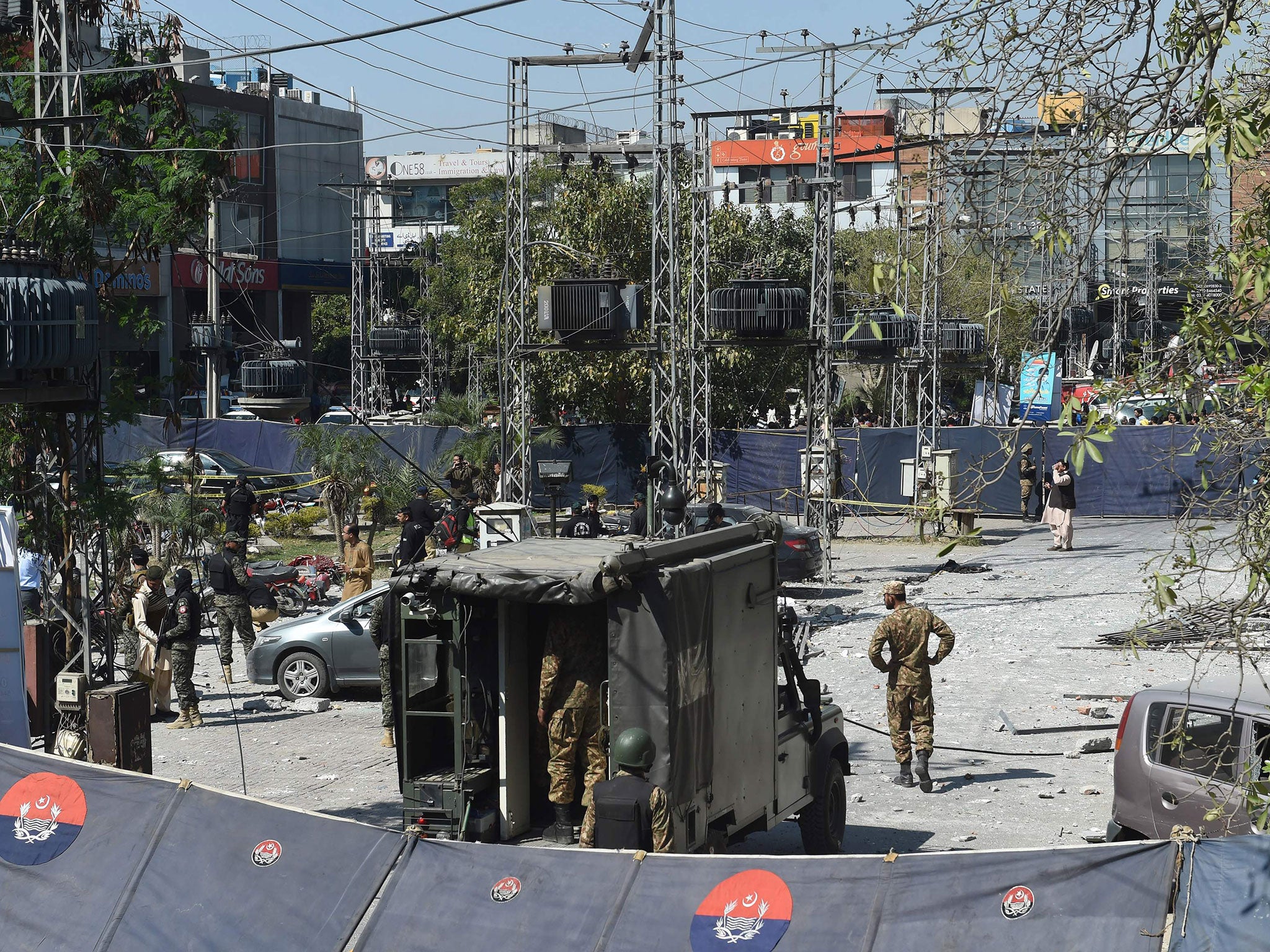 Pakistani security officials cordon off the site of a bomb attack in Lahore on February 23, 2017.