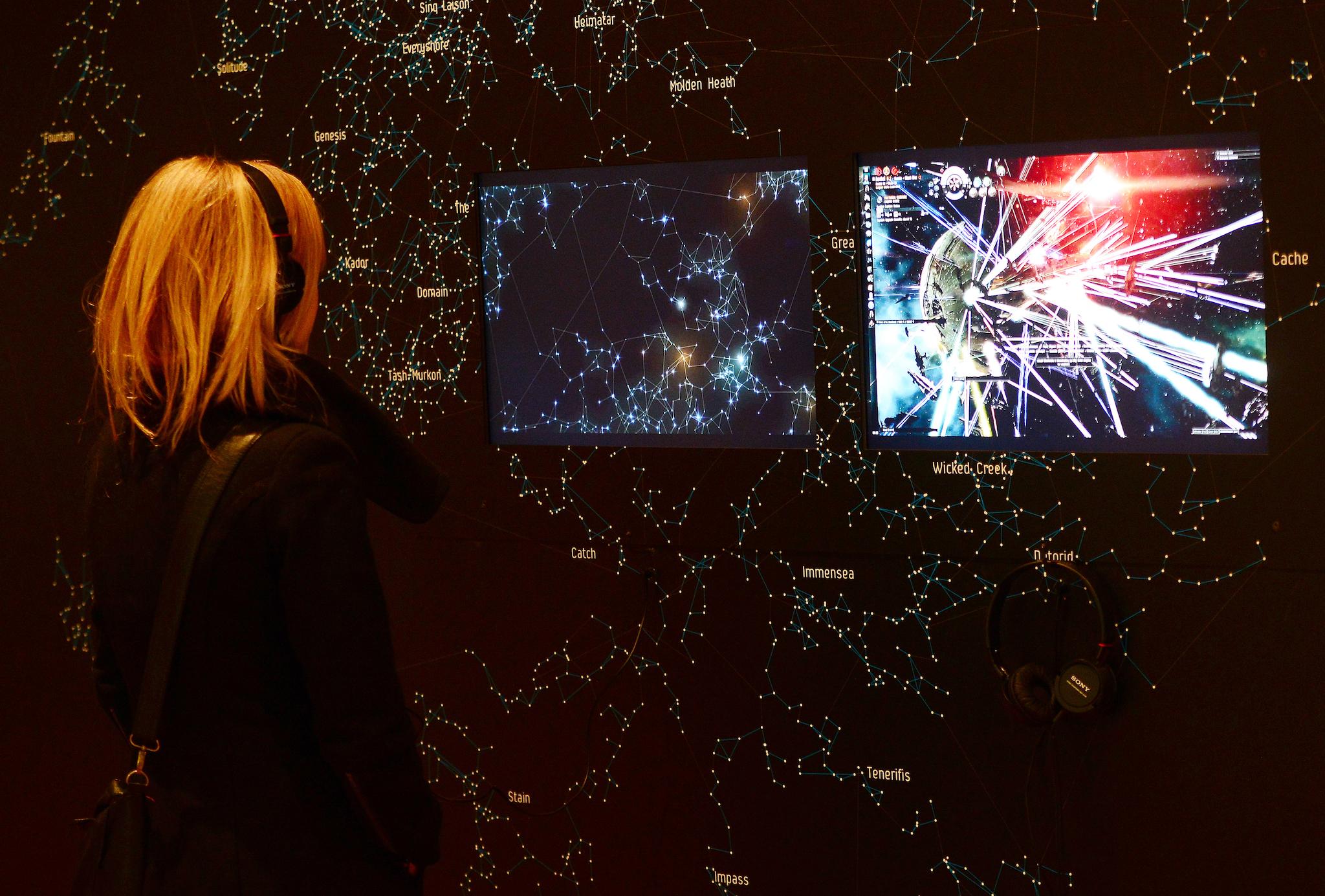 A visitor looks at a demonstration of the video game EVE Online (2003) during an exhibition preview featuring 14 video games acquired by The Museum of Modern Art (MoMA) in New York, March 1, 2013