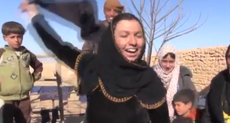 Women liberated from Isis in Syria take off face veils and burn them