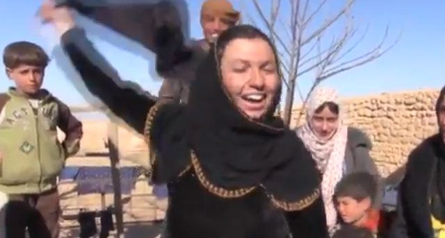 Syrian women remove their veils after being freed from Isis