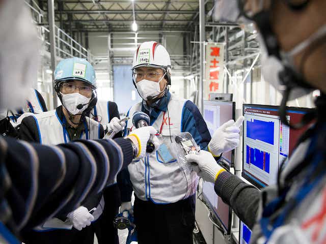 Workers of theTokyo Electric Power Co, which is tasked with the job to decommission the nuclear power plant in Okuma, Fukushima