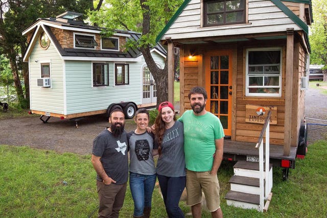 Christian Parsons (right) and Alexis Stephens (second right) outside their tiny home on wheels